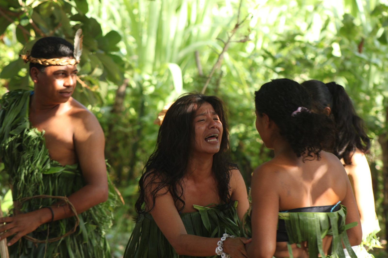 Performers in leaf costumes enacting a scene from island history