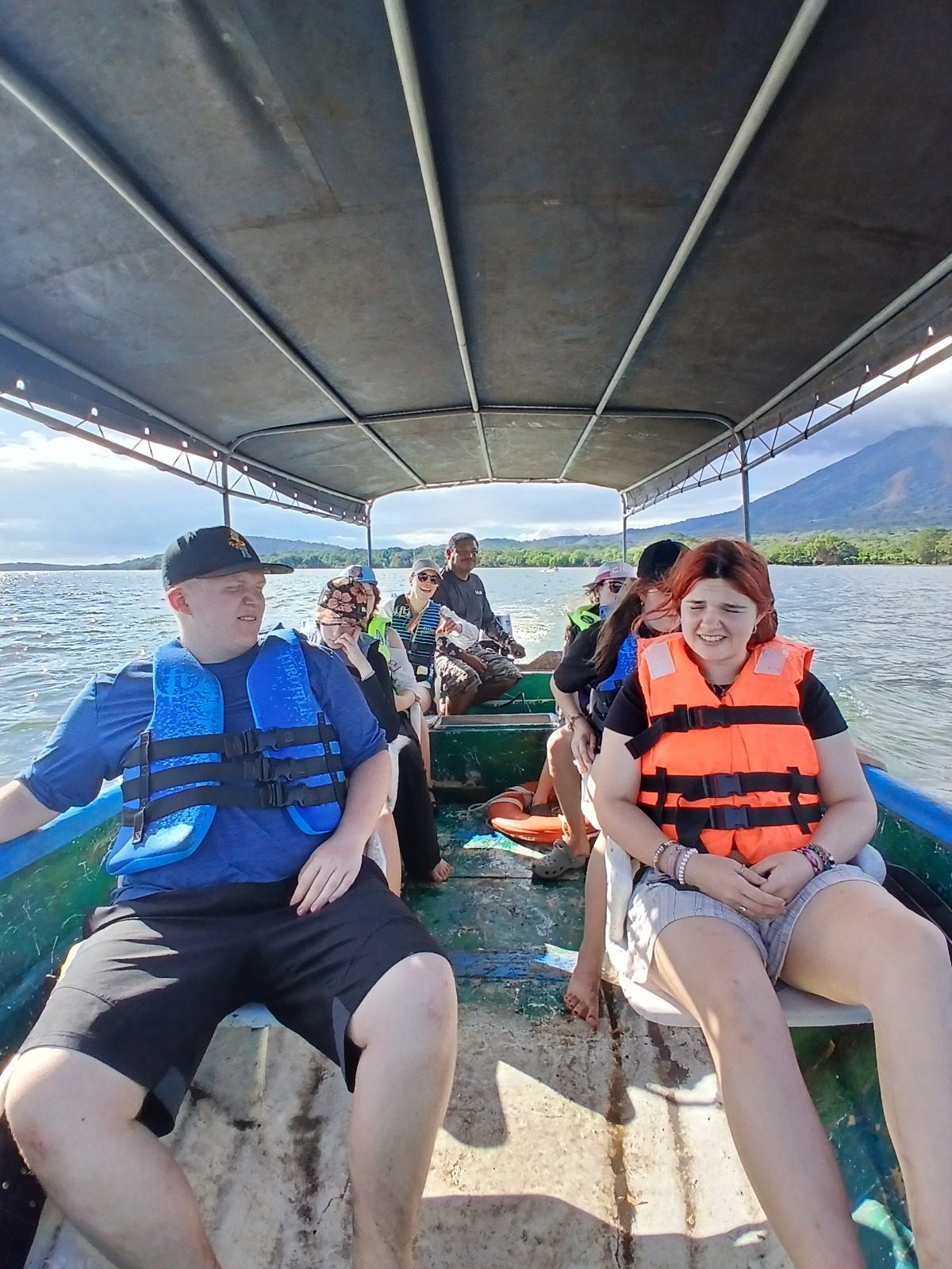 A group of visitors in life vests riding a motorized panga boat on Lake Nicaragua